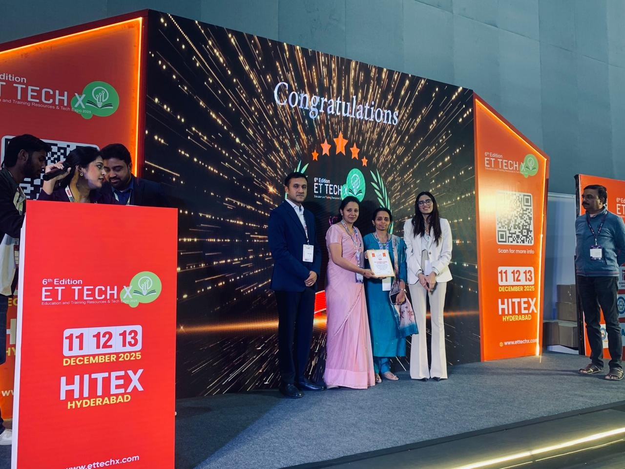 An Elegancia representative receiving recognition at an education event